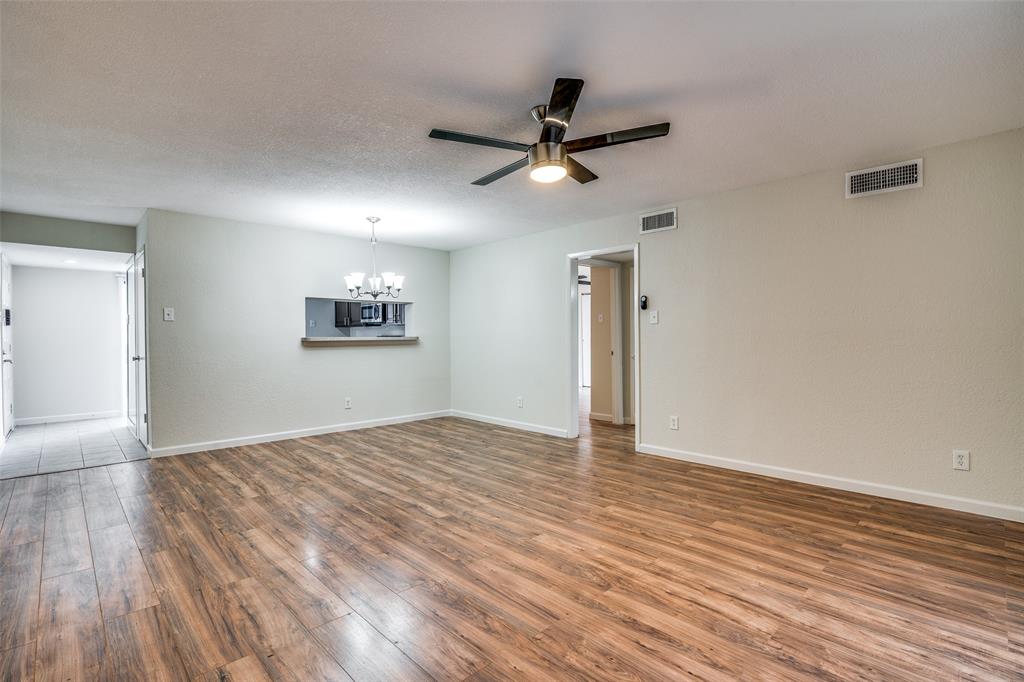 4535 North O'Connor Road, Unit 1218 Irving, TX 75062 - Photo 5 of 12 a view of empty room with wooden floor and fan