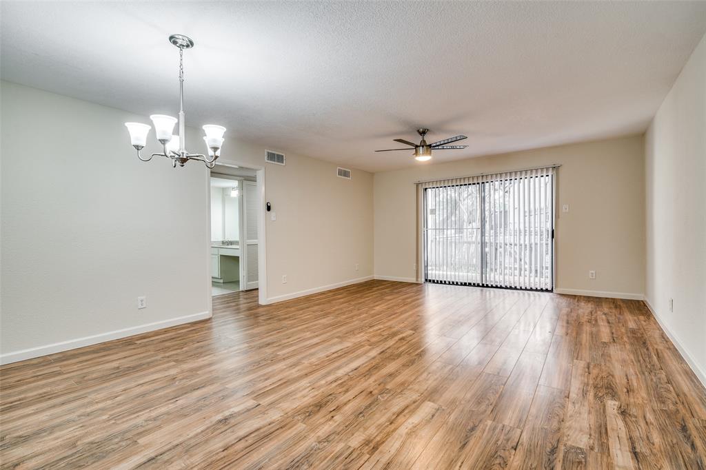 4535 North O'Connor Road, Unit 1218 Irving, TX 75062 - Photo 7 of 12 a view of a livingroom with wooden floor and a ceiling fan
