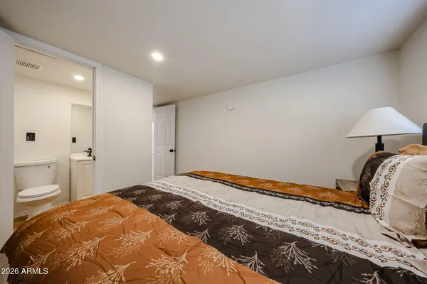 a bedroom with a bed and a lamp