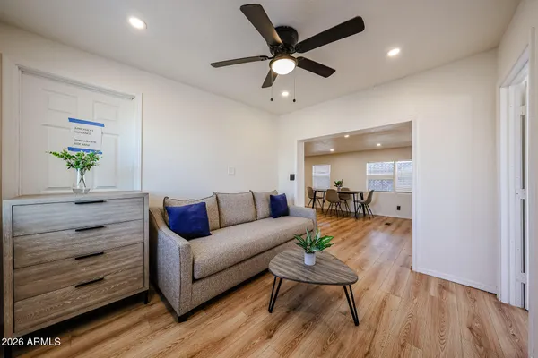 a living room with furniture and a wooden floor