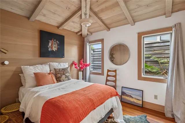 a bed room with a bed a mirror and a window