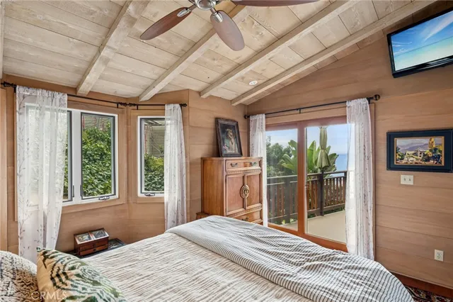 a bedroom with a bed and a large window with outer view