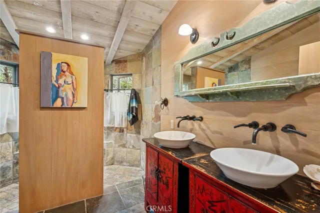 a bathroom with 2 sink and a mirror