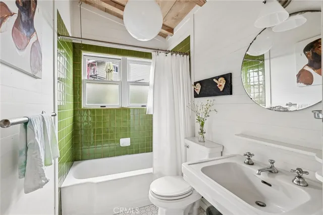a bathroom with a sink mirror toilet and bathtub