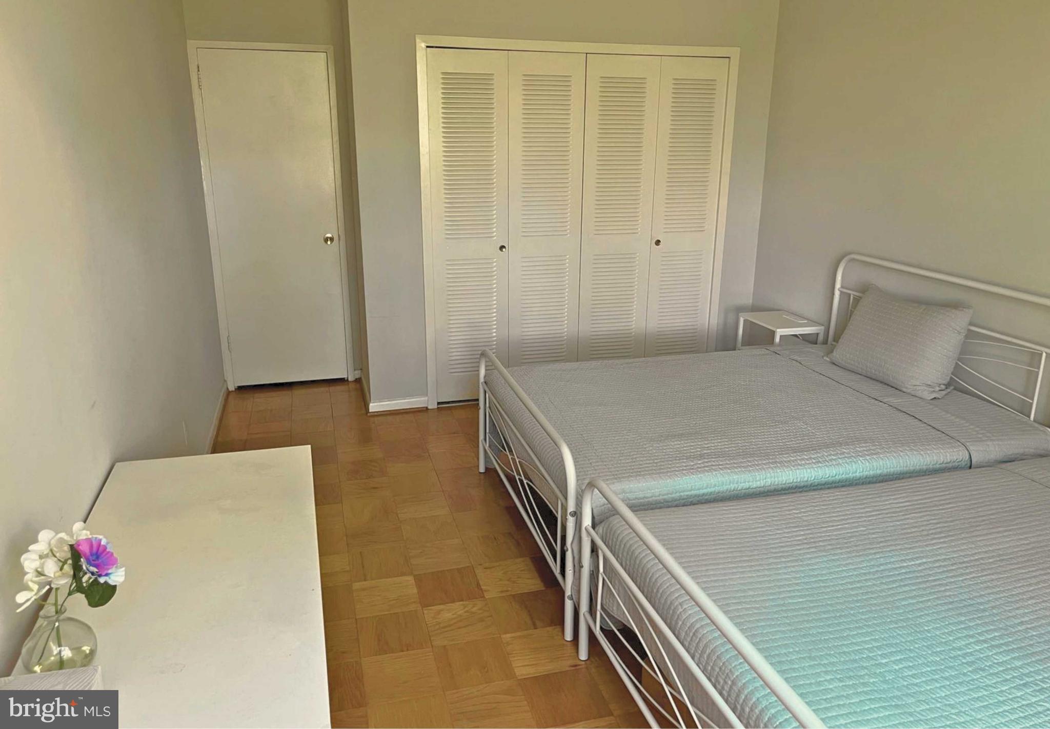 5101 River Road, Unit 405 Bethesda, MD 20816 - Photo 13 of 20 a bedroom with a bed and a dresser
