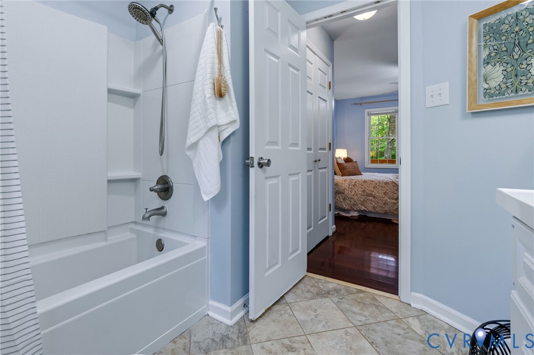 2869 Newville Road Disputanta, VA 23842 - Photo 13 of 26 Bathtub with shower fixture, tiled flooring, and a