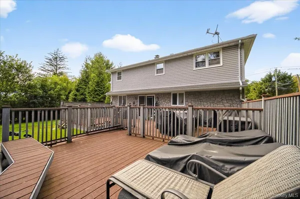 a view of roof deck with wooden floor and seating space