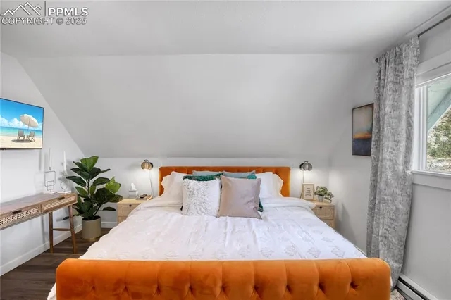 a bedroom with a bed and a potted plant