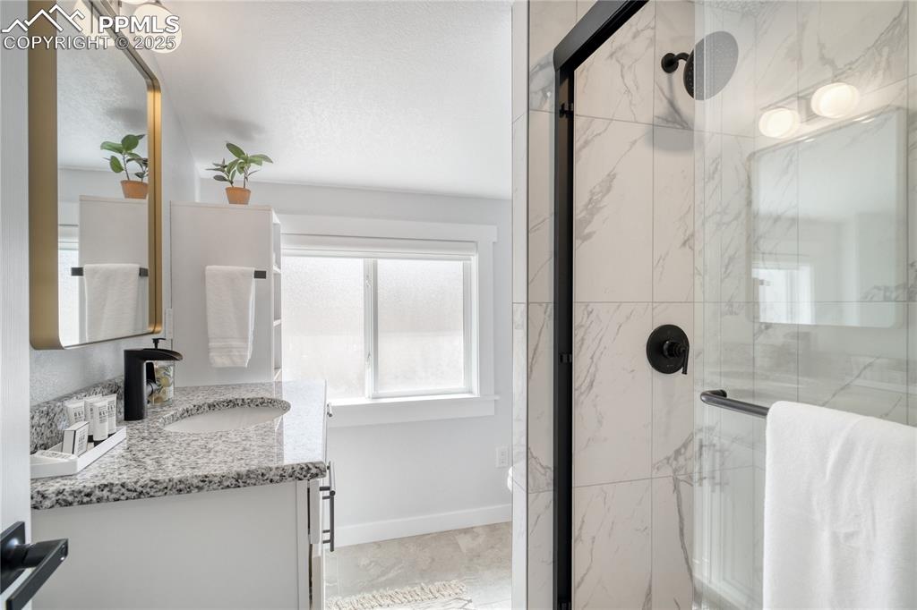 7101 Highway 50 Salida, CO 81201 - Photo 26 of 50 a bathroom with a granite countertop sink a mirror and shower