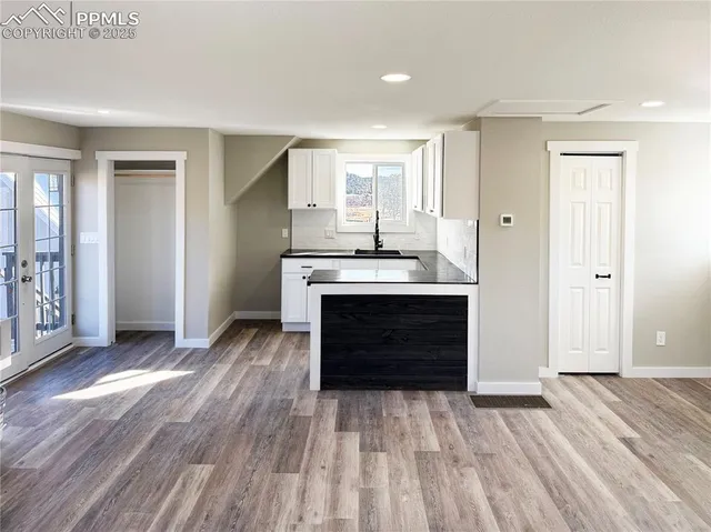 a view of kitchen with wooden floor electronic appliances and window