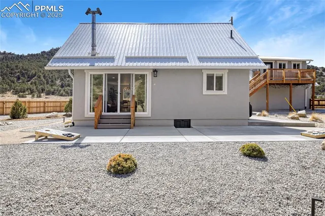 a backyard of a house with barbeque oven table and chairs