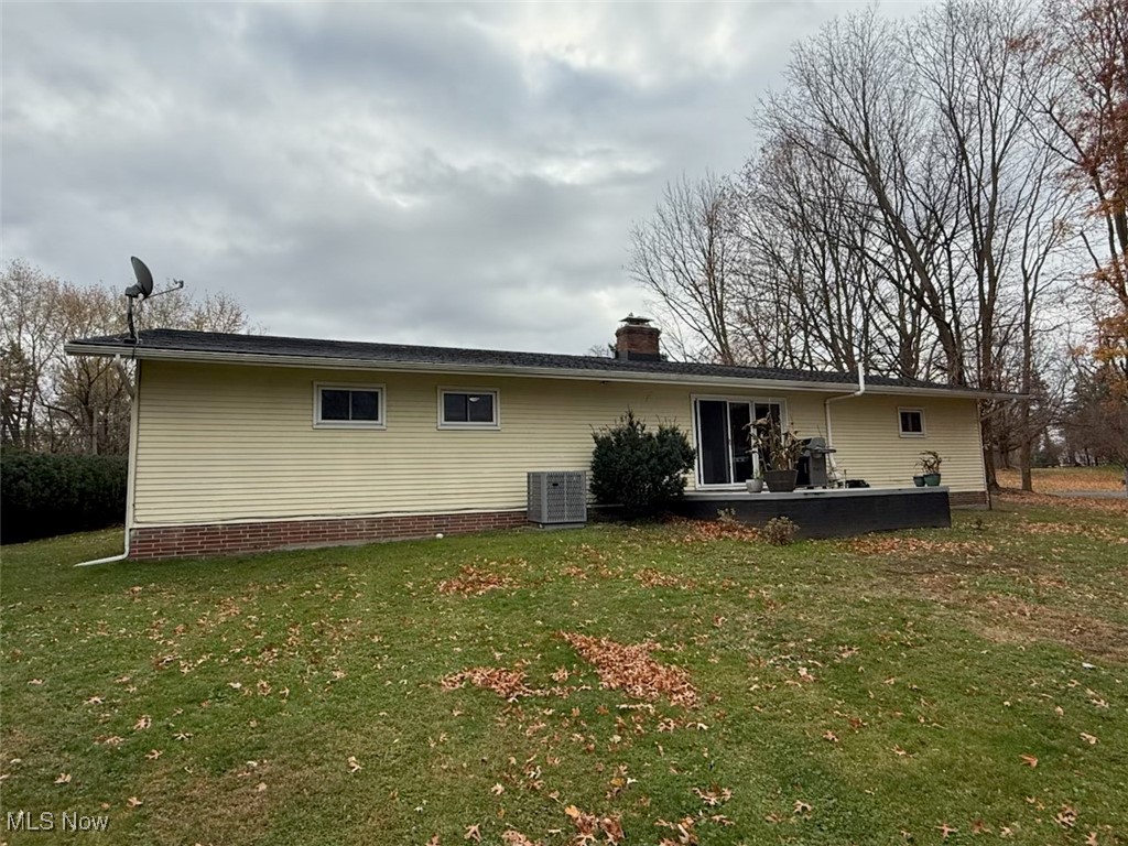 10719 Johnnycake Ridge Road Painesville, OH 44077 - Photo 20 of 21 Rear view of property with a yard and a chimney