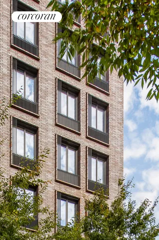 a view of a tall building next to a road