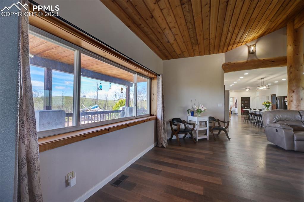 13880 Eastonville Road Elbert, CO 80106 - Photo 11 of 44 a dining room with furniture wooden floor and a floor to ceiling window