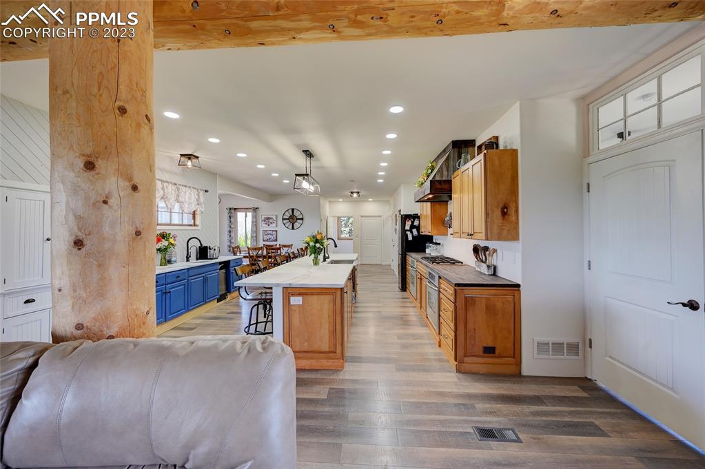 13880 Eastonville Road Elbert, CO 80106 - Photo 12 of 44 a living room with stainless steel appliances kitchen island granite countertop furniture and a kitchen view