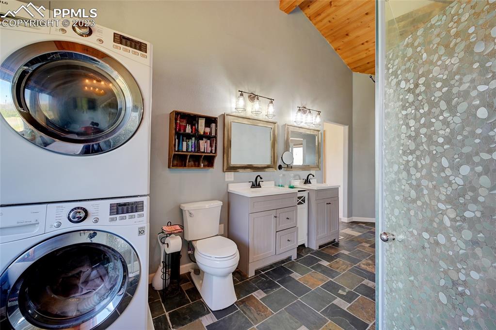 13880 Eastonville Road Elbert, CO 80106 - Photo 18 of 44 a spacious bathroom with a toilet sink vanity and mirror