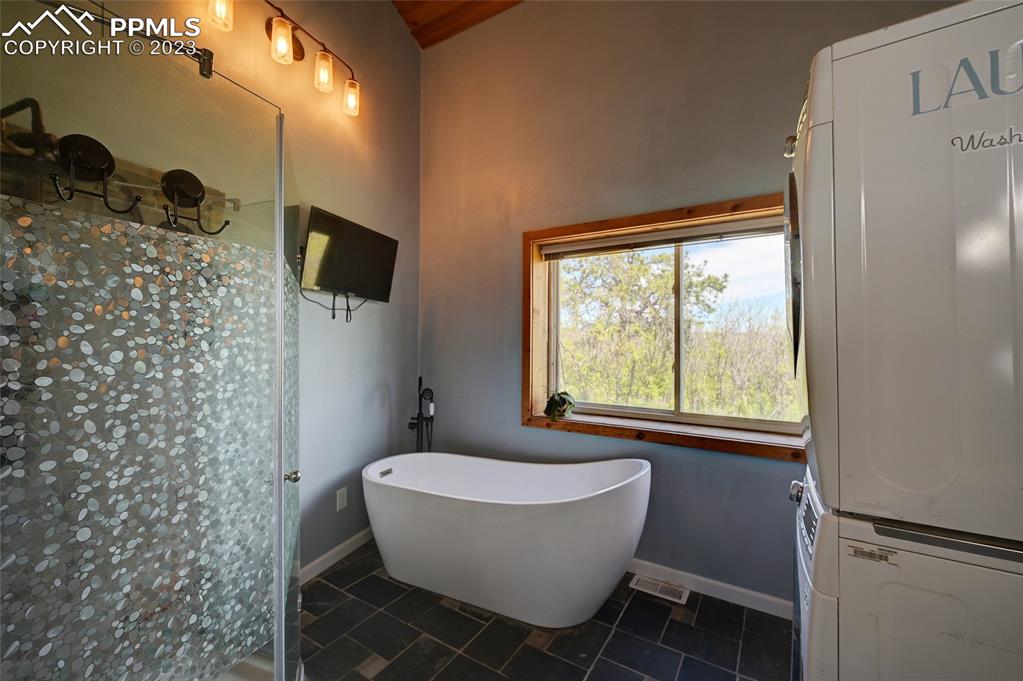 13880 Eastonville Road Elbert, CO 80106 - Photo 19 of 44 a bathroom with a granite countertop sink toilet a mirror and shower