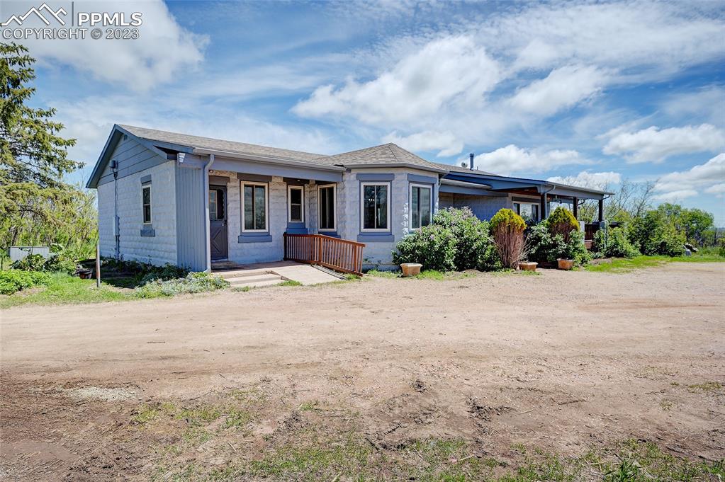 13880 Eastonville Road Elbert, CO 80106 - Photo 2 of 44 a front view of house with yard and trees around