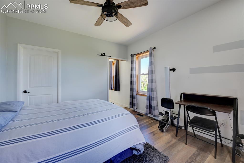 13880 Eastonville Road Elbert, CO 80106 - Photo 21 of 44 a bedroom with a bed a desk and chair