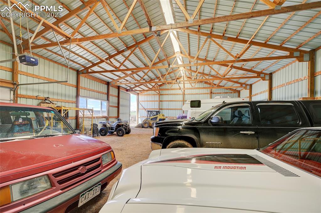 13880 Eastonville Road Elbert, CO 80106 - Photo 36 of 44 a view of a patio with a table and chairs under an umbrella with a barbeque grill and couches
