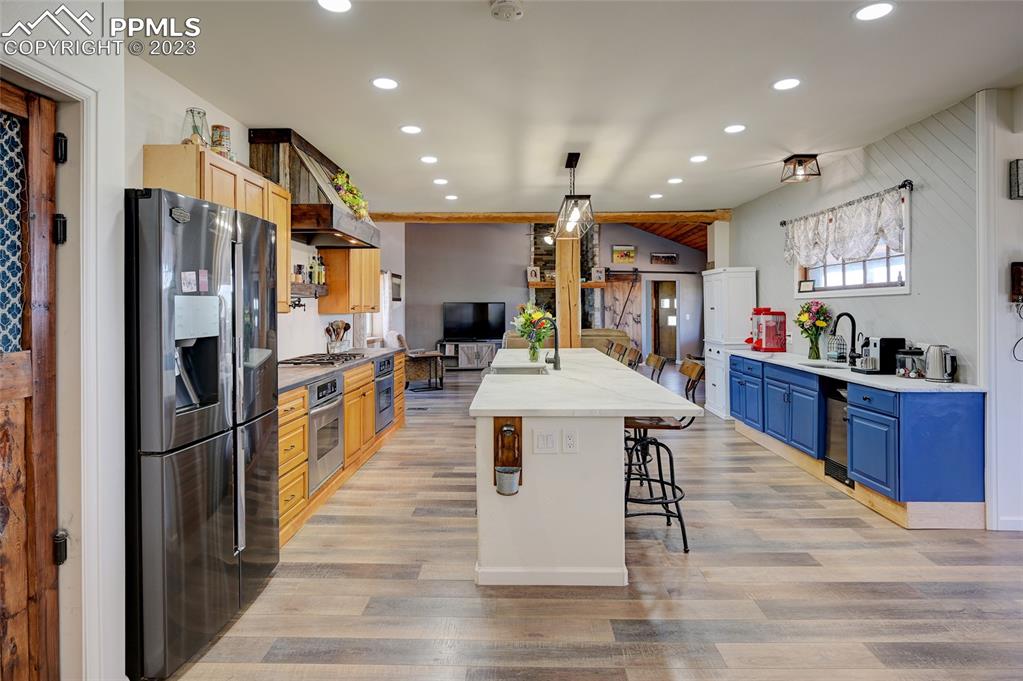 13880 Eastonville Road Elbert, CO 80106 - Photo 8 of 44 a kitchen with stainless steel appliances kitchen island granite countertop a refrigerator a stove and a sink