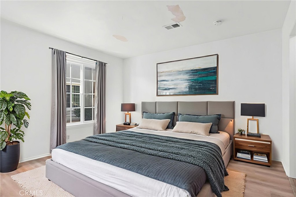 1845 Anaheim Avenue Costa Mesa, CA 92627 - Photo 9 of 13 a bedroom with a large bed and a potted plant