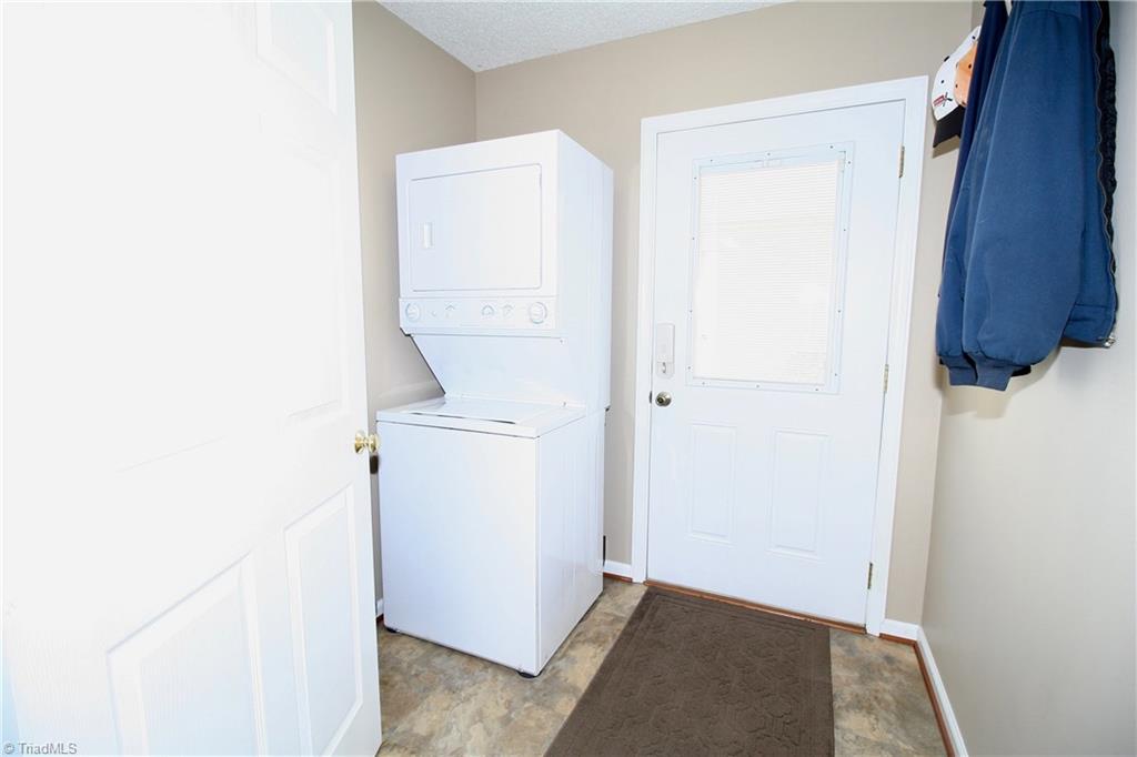 7114 Harper Ridge Court Oak Ridge, NC 27310 - Photo 9 of 28 Laundry room off kitchen. Side door leads to breezeway to detached garage.