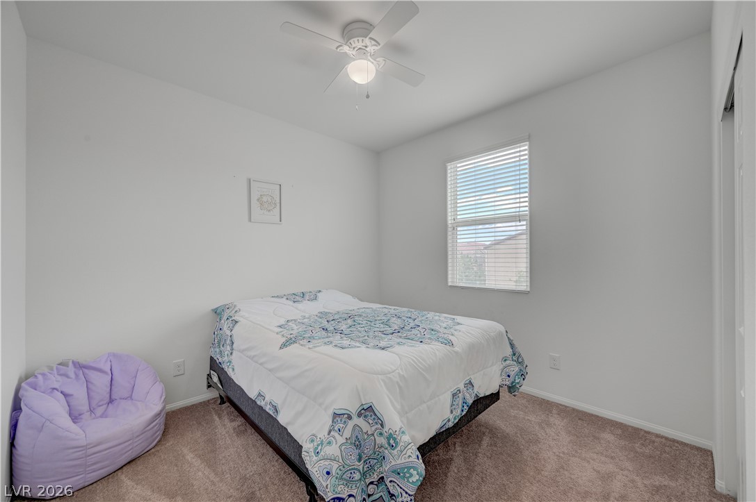 1287 Raritan Place Henderson, NV 89002 - Photo 15 of 21 Comfortable bedroom with carpeted floors and a ceiling fan for year-round comfort.