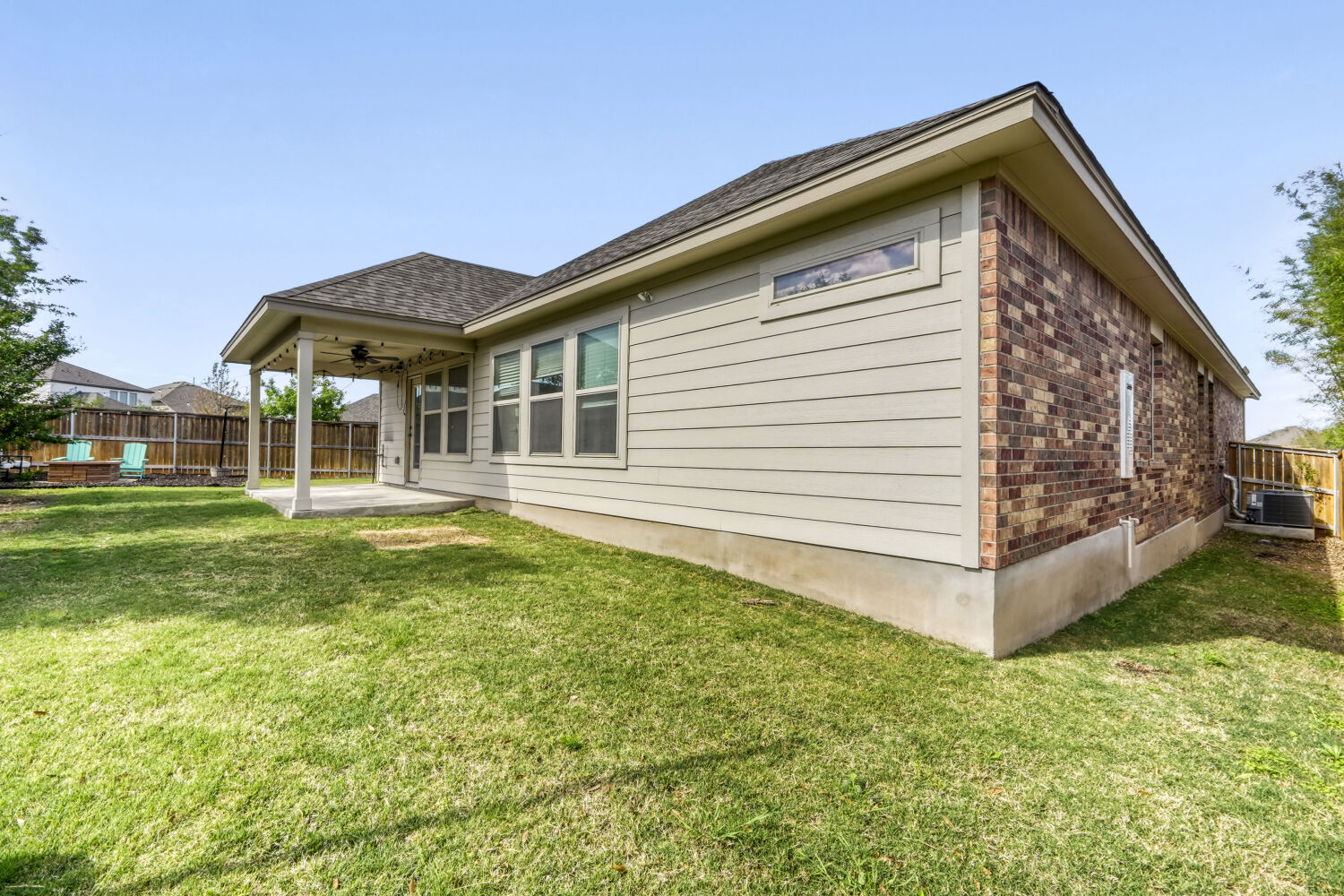 426 Cold Riv Run Kyle, TX 78640 - Photo 18 of 24 Exterior features brick siding, a ceiling fan, a patio, and a shingled roof