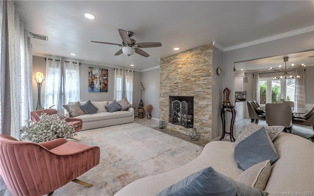 39 Kingston Road Trumbull, CT 06611 - Photo 1 of 1 a living room with furniture and a fireplace