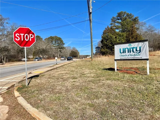 a view of a street sign under a blue umbrella