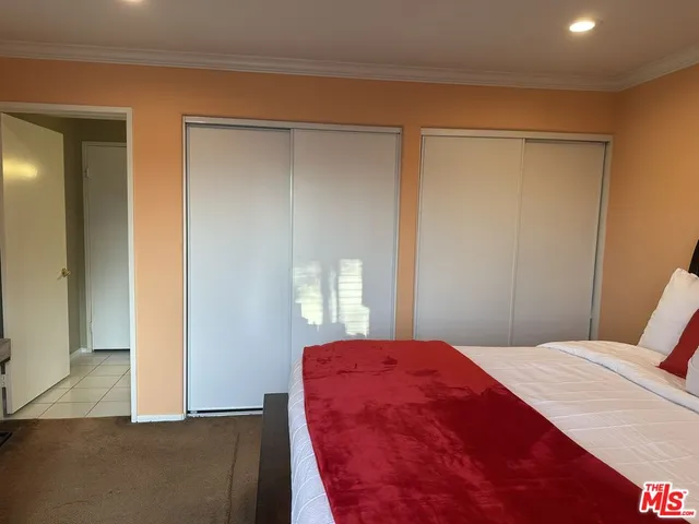 a bedroom with a bed and a mirror