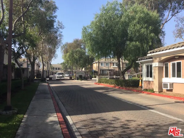 a city street lined with buildings and trees