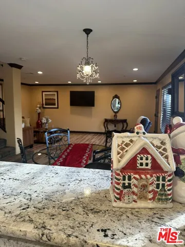 a bed room with a bed mirror and a chandelier