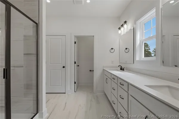 a bathroom with a double vanity sink and mirror