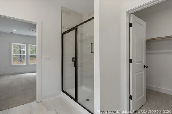 a bathroom with a double vanity sink a mirror and a shower