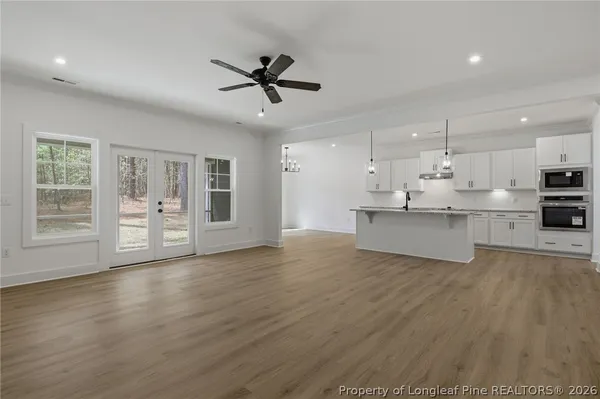 a spacious bathroom with a double vanity sink a large mirror and a shower