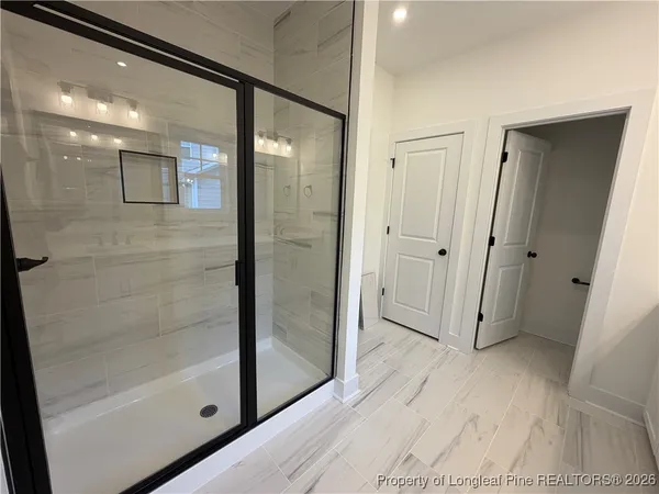 a hallway with sink and mirror
