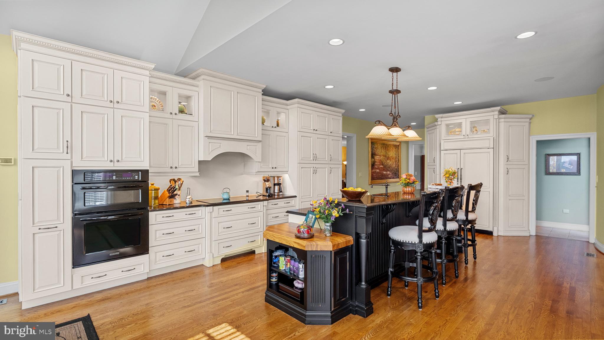 927 Western Road Hunt Valley, MD 21030 - Photo 24 of 80 a kitchen with stainless steel appliances granite countertop a stove top oven a sink dishwasher a dining table and chairs with wooden floor