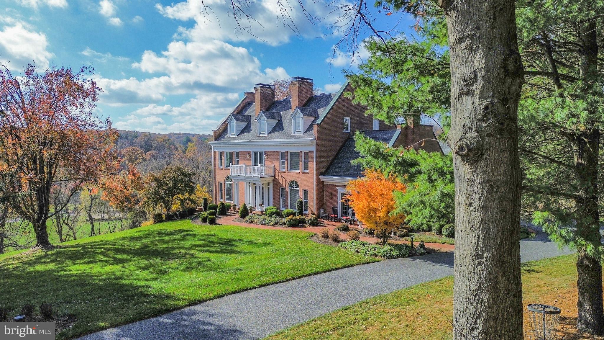 927 Western Road Hunt Valley, MD 21030 - Photo 5 of 80 a view of a big house with a big yard and large trees