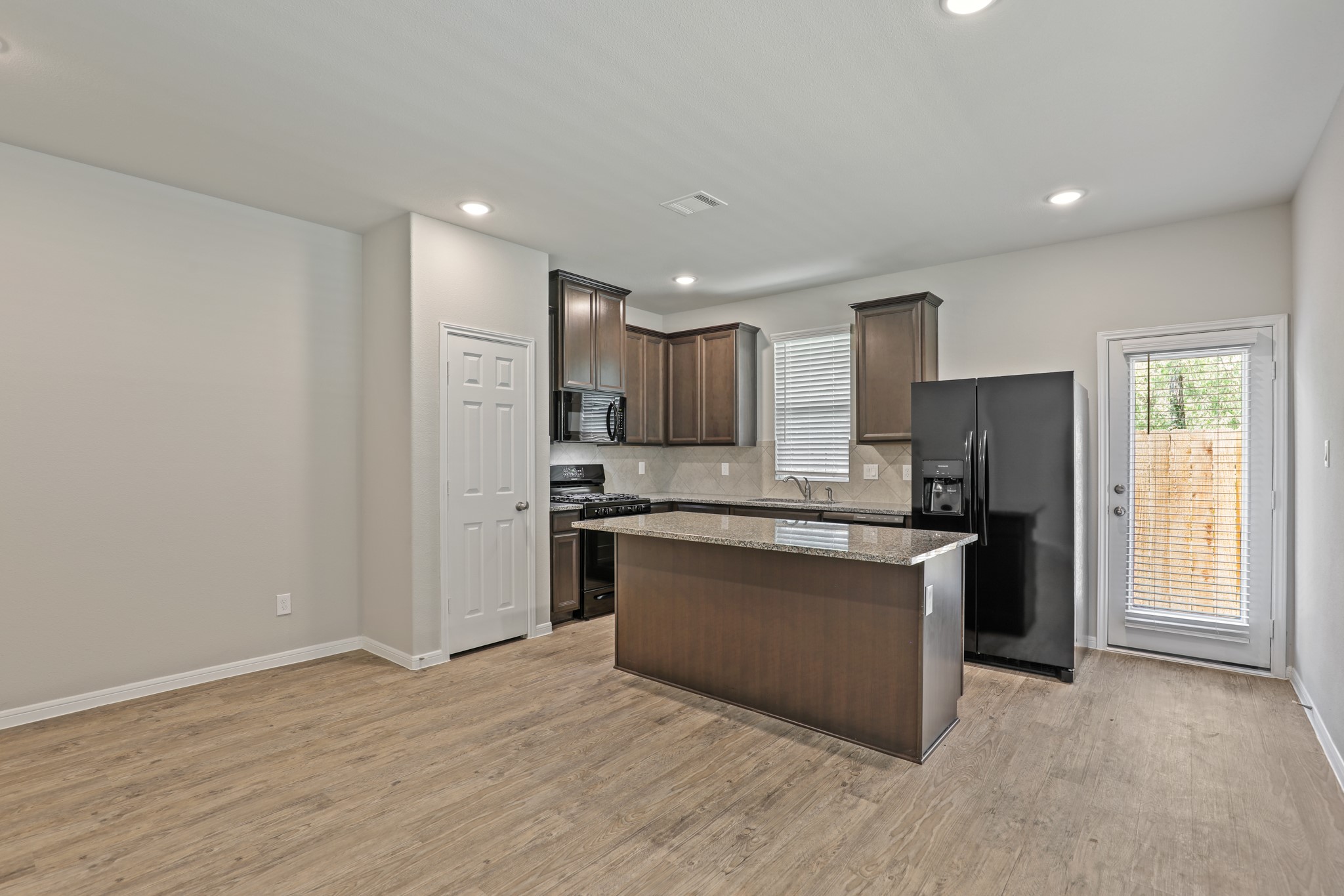 13514 Axel Lane Houston, TX 77047 - Photo 17 of 34 a kitchen with stainless steel appliances granite countertop a refrigerator and a stove top oven