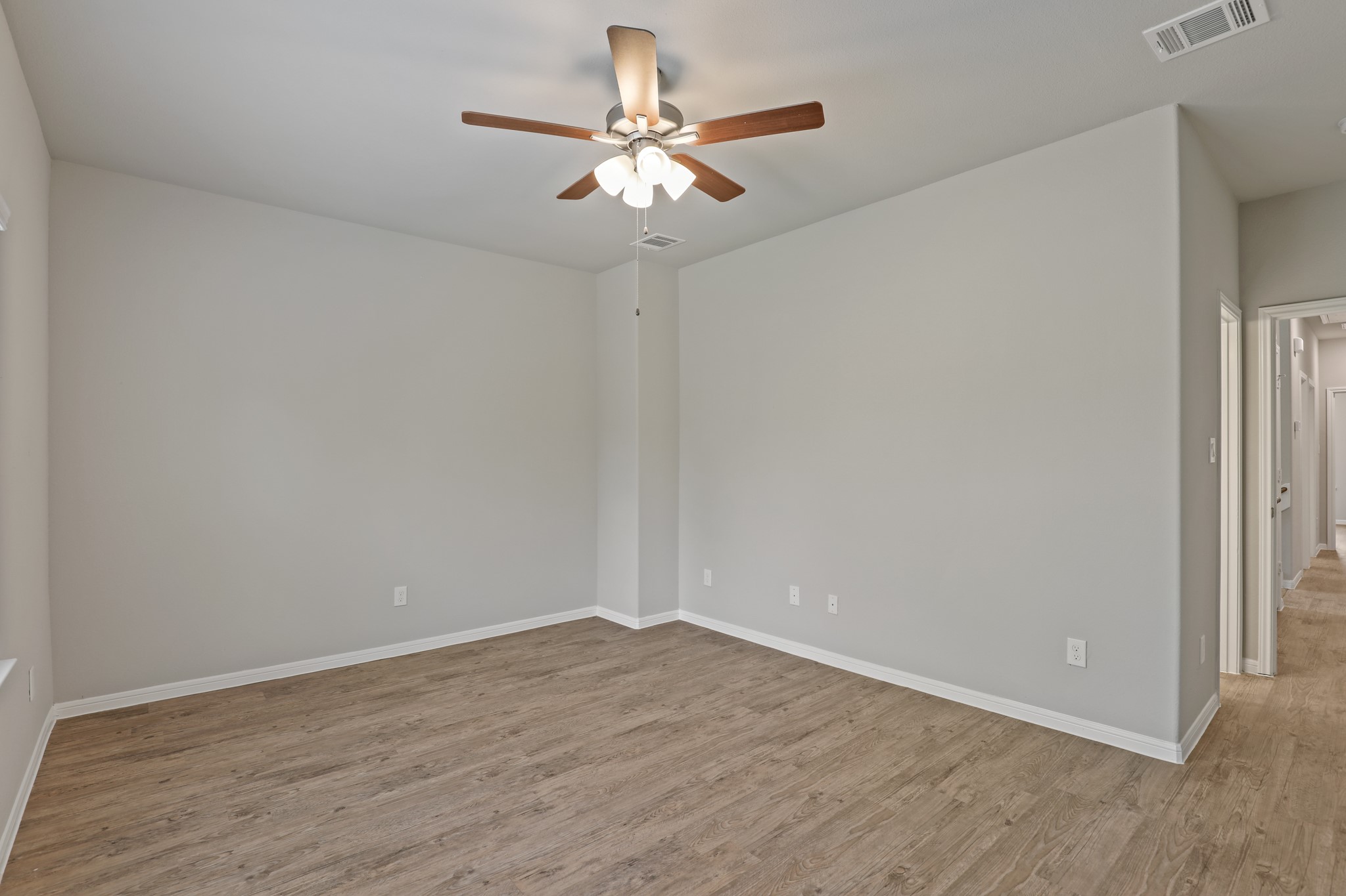 13514 Axel Lane Houston, TX 77047 - Photo 19 of 34 a view of a room with wooden floor and a ceiling fan