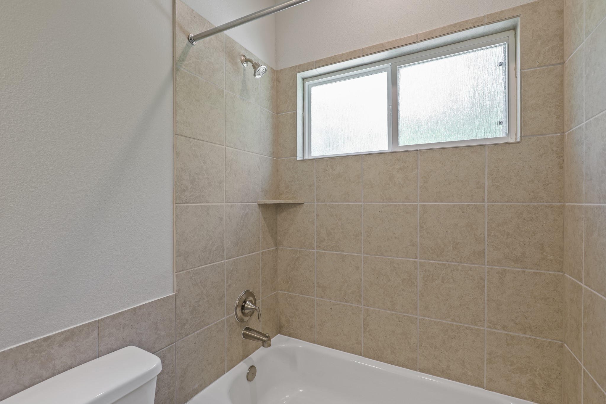 13514 Axel Lane Houston, TX 77047 - Photo 34 of 34 a bathroom with a bathtub and window