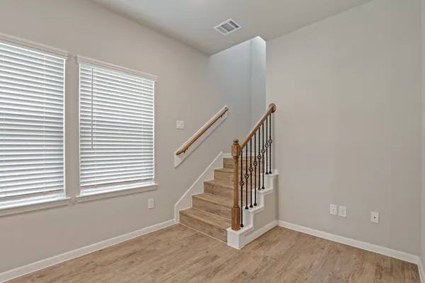 a view of entryway and hall with wooden floor