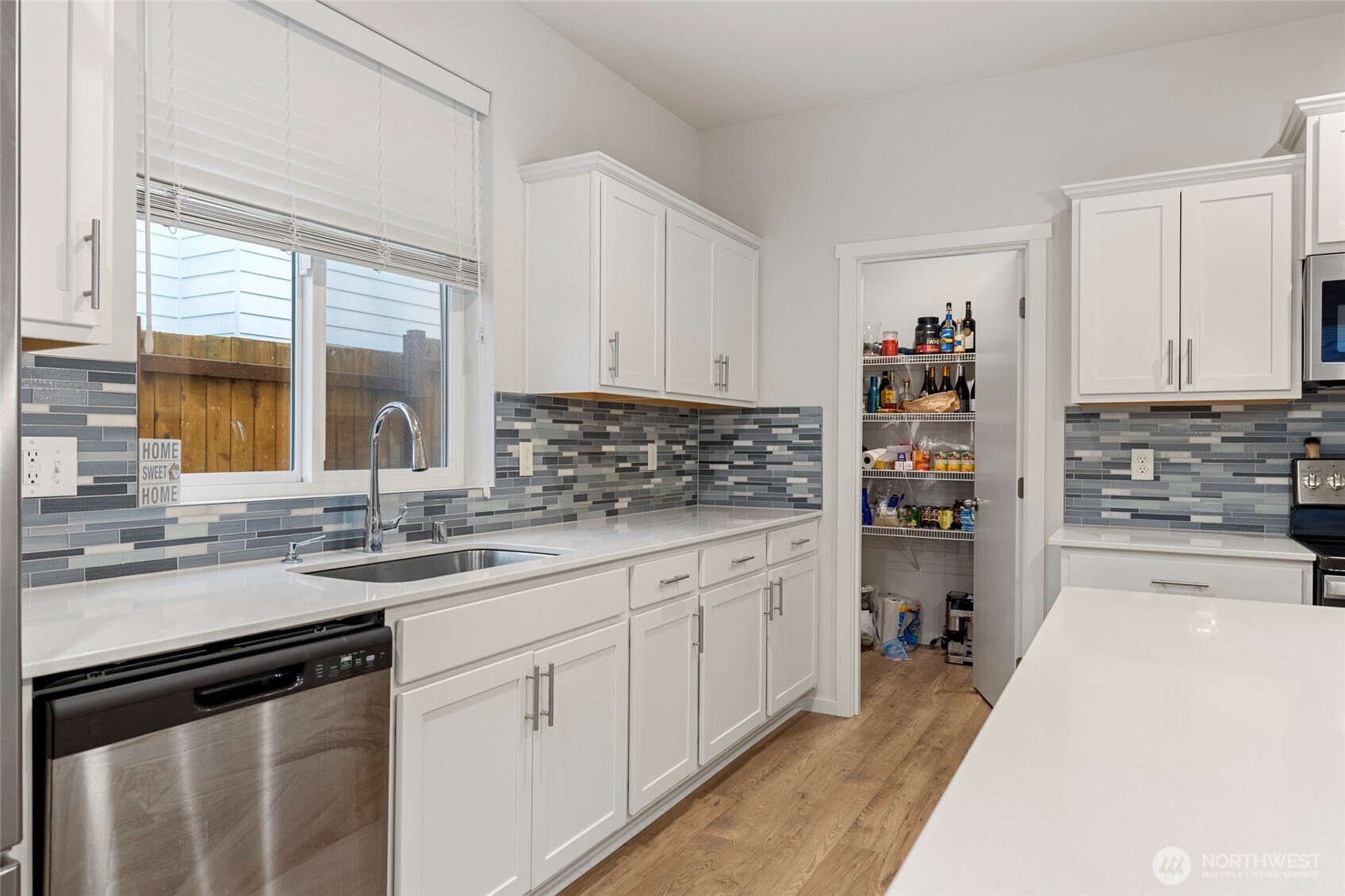 2113 Lancaster Way Ferndale, WA 98248 - Photo 11 of 32 a kitchen with granite countertop a sink stove and cabinets
