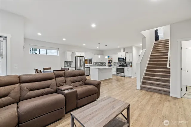 a living room with furniture and wooden floor