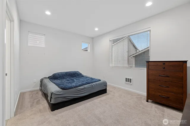 a living room with furniture and a dresser