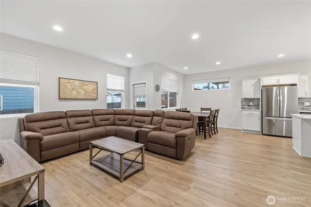 a living room with furniture window and a wooden floor