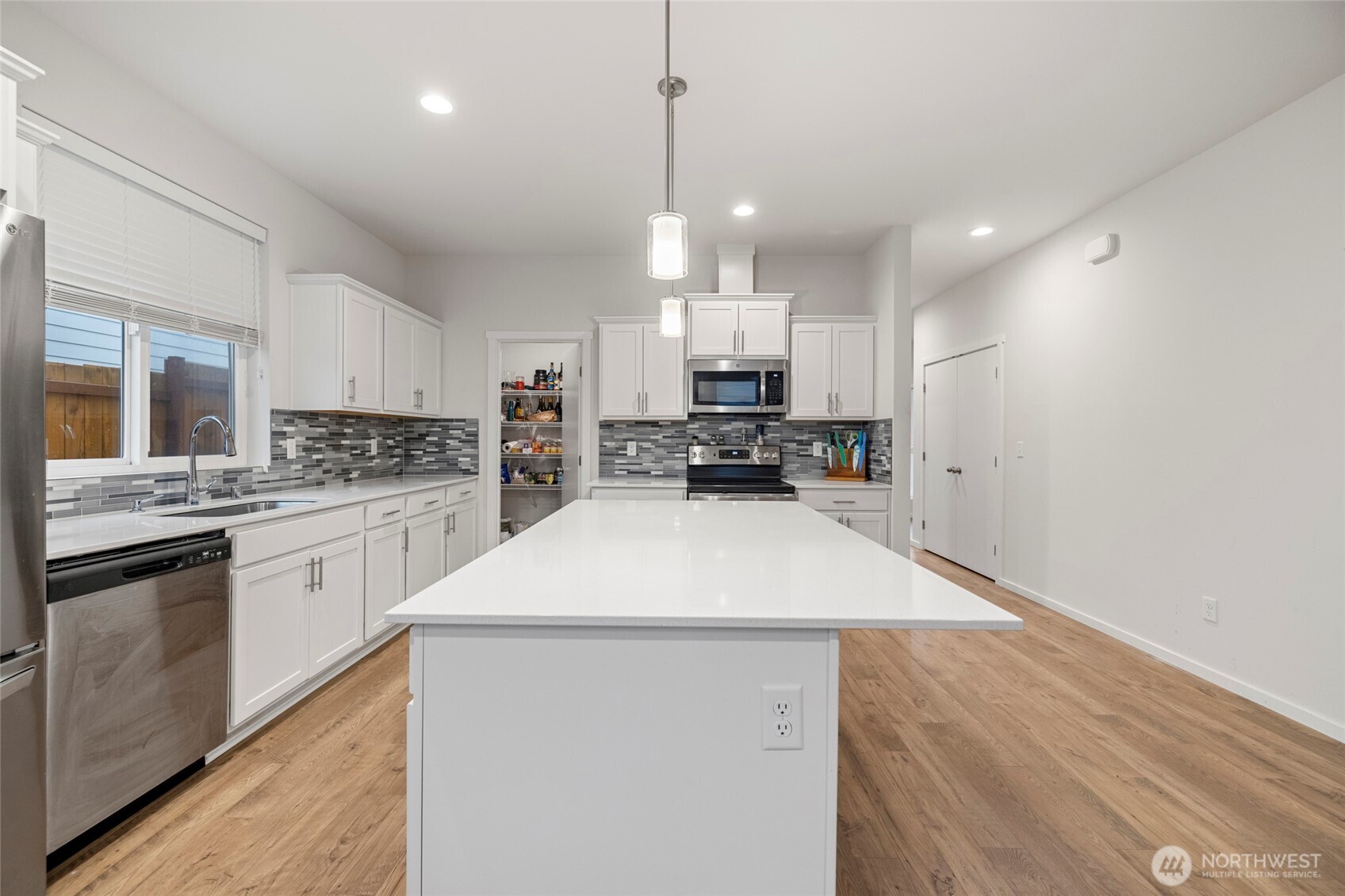 2113 Lancaster Way Ferndale, WA 98248 - Photo 9 of 32 a kitchen with stainless steel appliances a refrigerator sink and stove