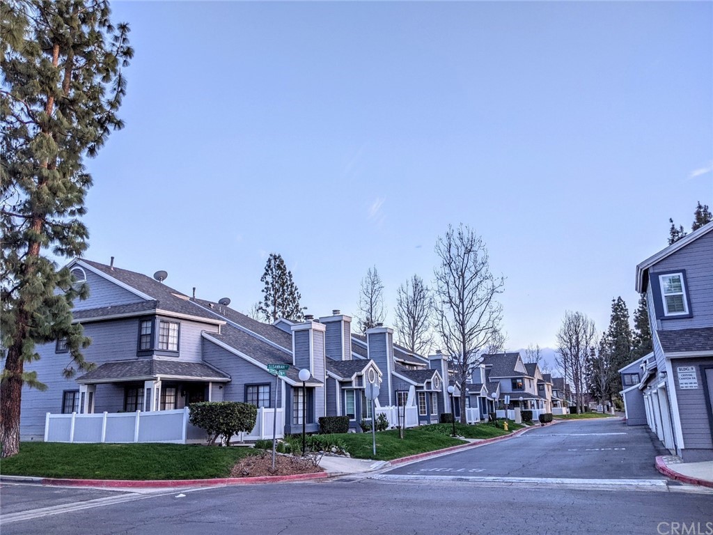 1641 Dimas Court Azusa, CA 91702 - Photo 14 of 14 a front view of residential houses with yard and trees